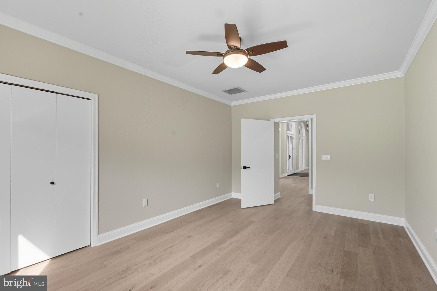 9171 Deepwater Point Road St. Michaels, MD 21663 - Photo 24 of 40 a view of a room with wooden floor and ceiling fan