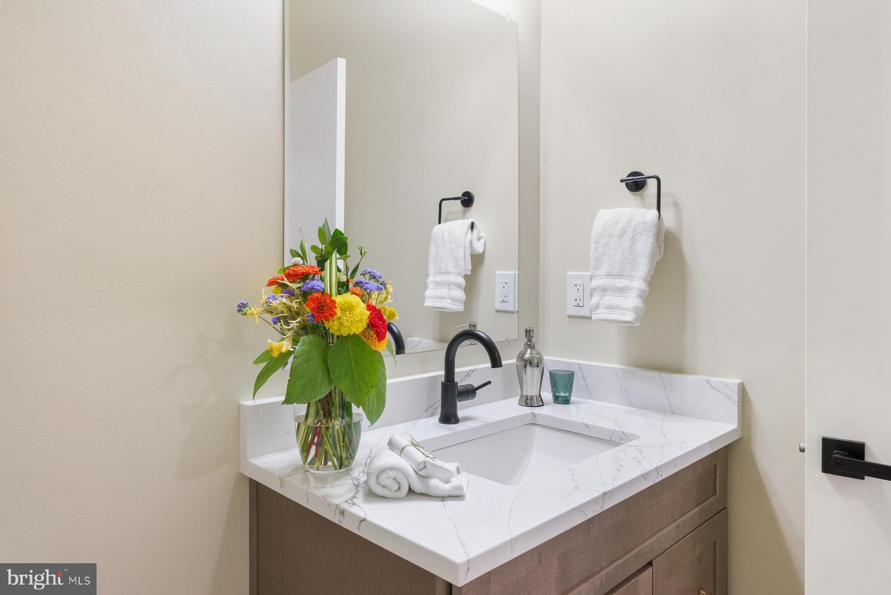 9171 Deepwater Point Road St. Michaels, MD 21663 - Photo 25 of 40 a bathroom with a sink and a mirror
