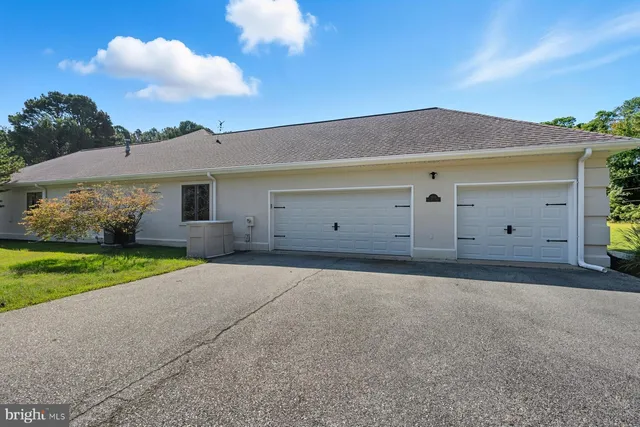 a view of a house with a yard and garage
