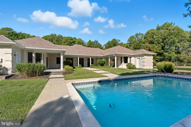 a house with swimming pool in front of it
