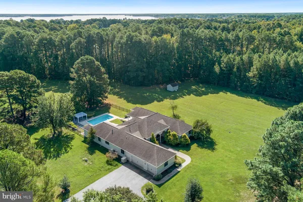 an aerial view of a houses with a yard