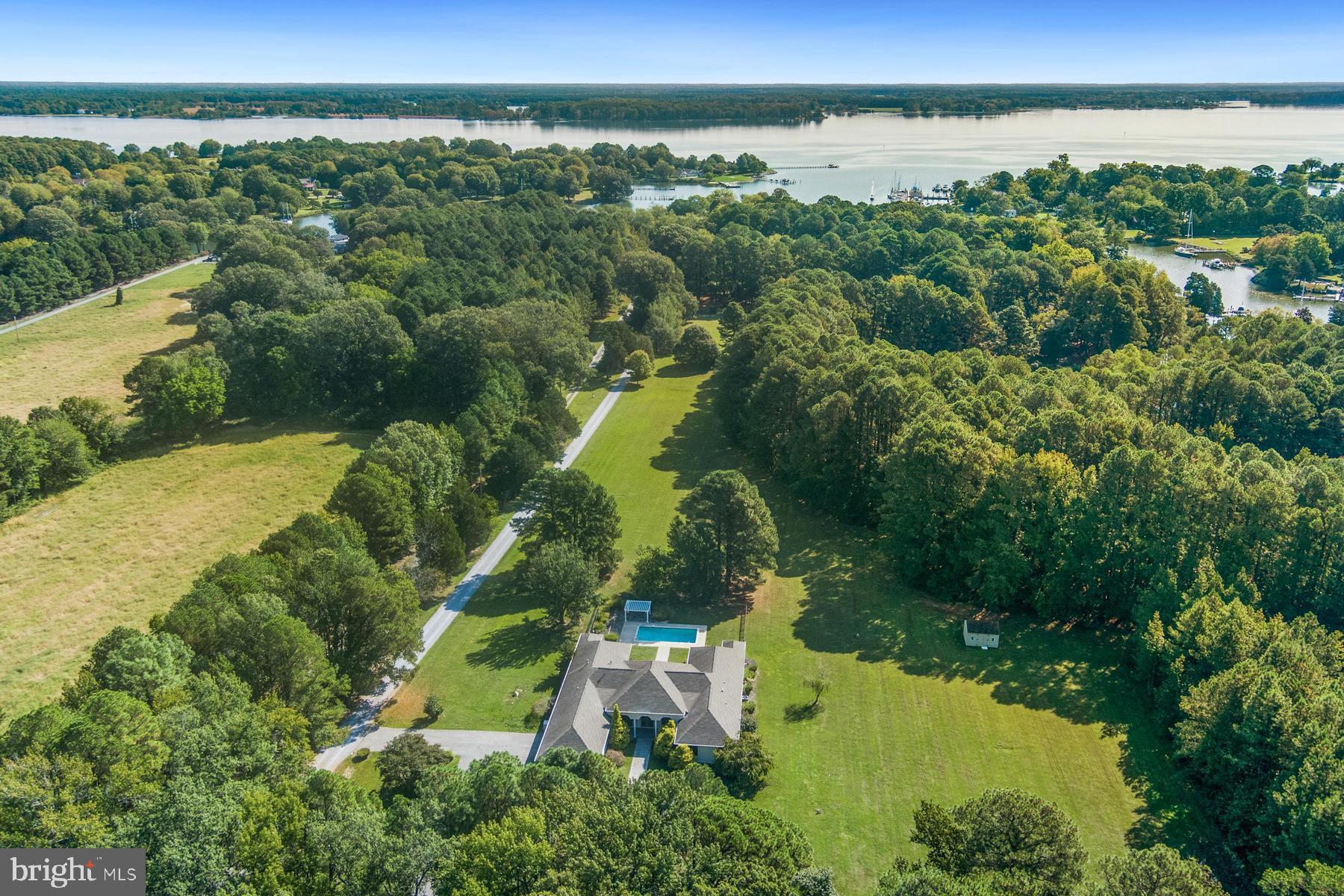 9171 Deepwater Point Road St. Michaels, MD 21663 - Photo 40 of 40 an aerial view of green landscape with trees houses and lake view