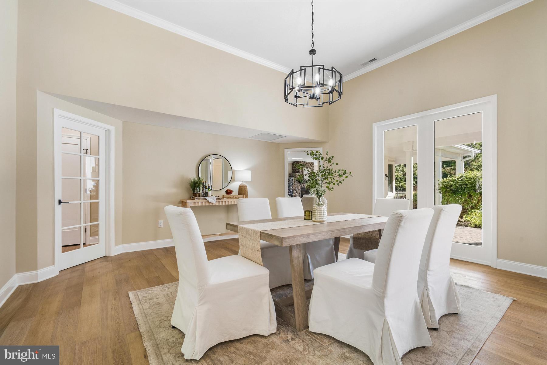 9171 Deepwater Point Road St. Michaels, MD 21663 - Photo 6 of 40 a view of a dining room with furniture window and wooden floor