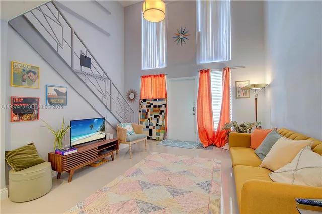 a kitchen with stainless steel appliances kitchen island granite countertop a refrigerator and a dining table