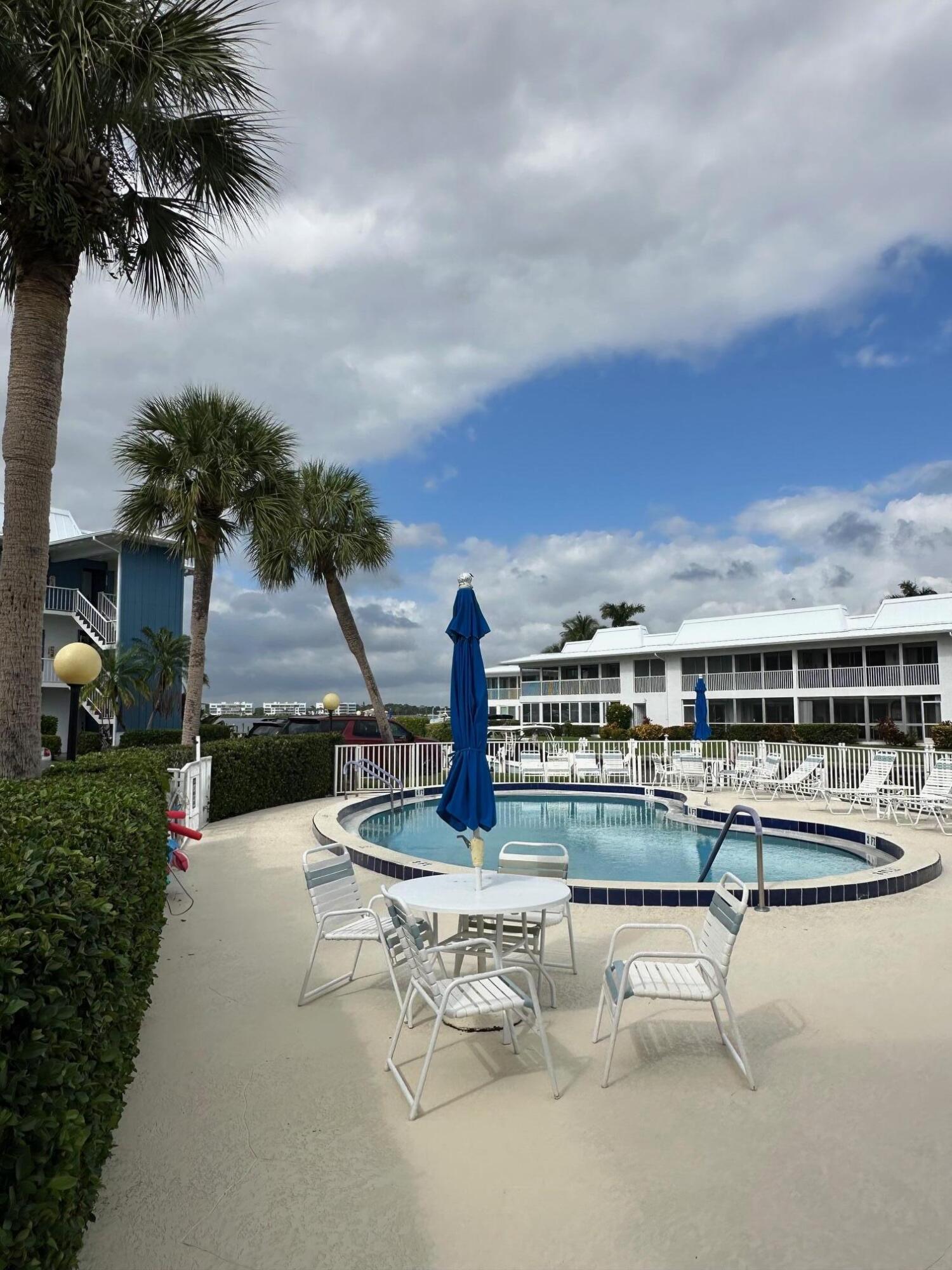 1868 Southwest Palm City Road, Unit 202 Stuart, FL 34994 - Photo 17 of 18 a view of a lake with a terrace