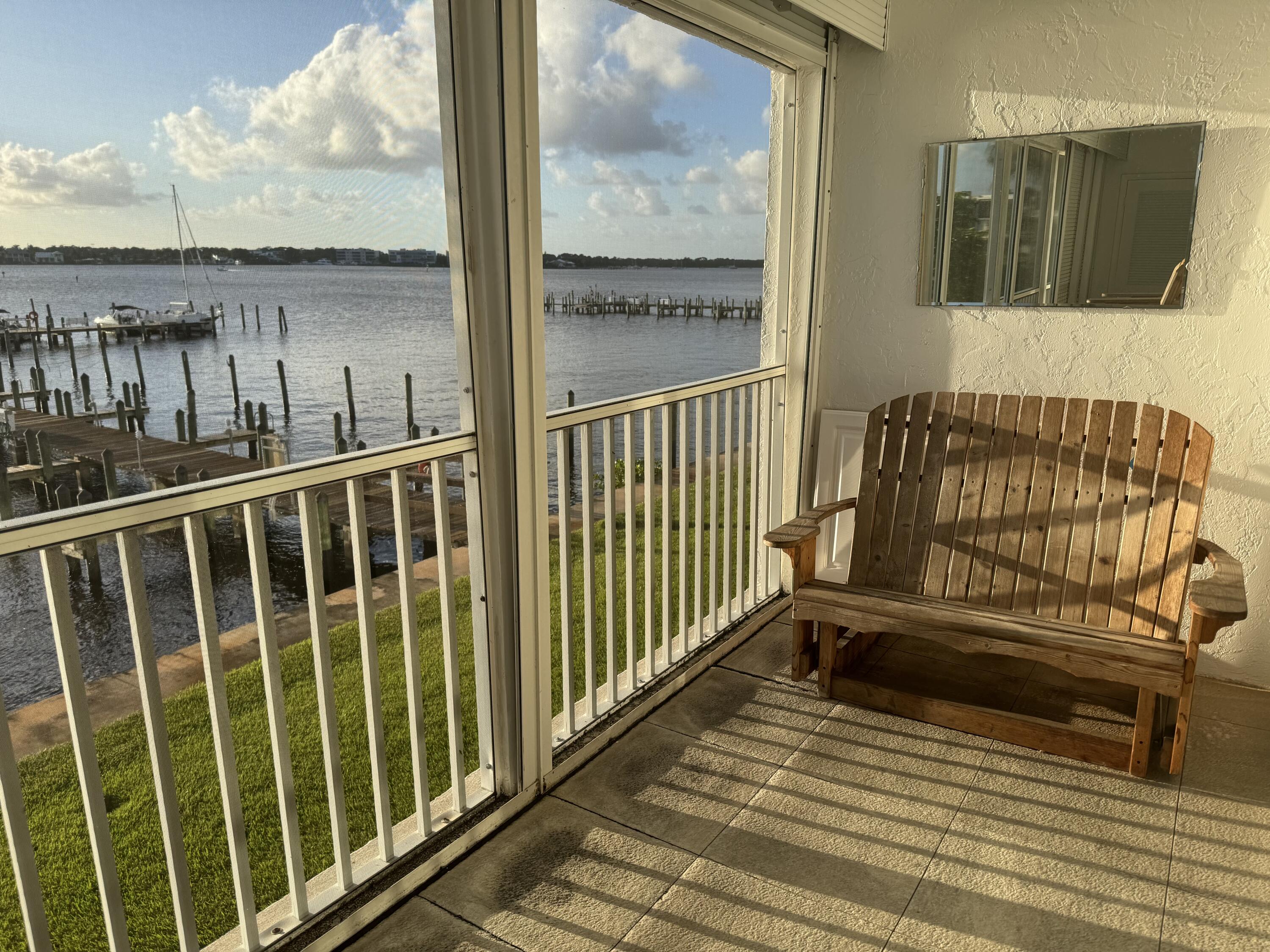 1868 Southwest Palm City Road, Unit 202 Stuart, FL 34994 - Photo 3 of 18 a view of a balcony with wooden floor