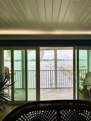 a view of a room with wooden floor and furniture