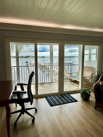 a view of a livingroom with furniture and floor to ceiling window