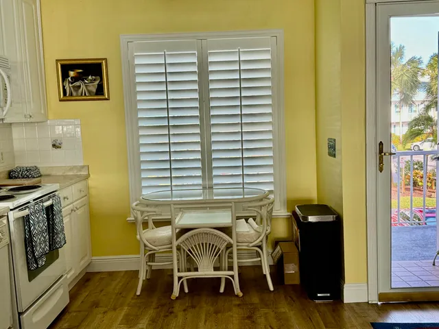 a dining room with furniture and a window
