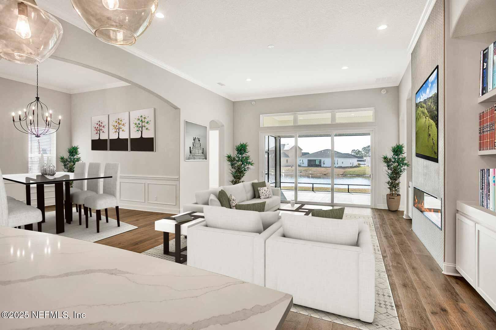 531 Eagle Moon Lake Drive St. Augustine, FL 32092 - Photo 33 of 36 a living room with furniture large window and flat screen tv