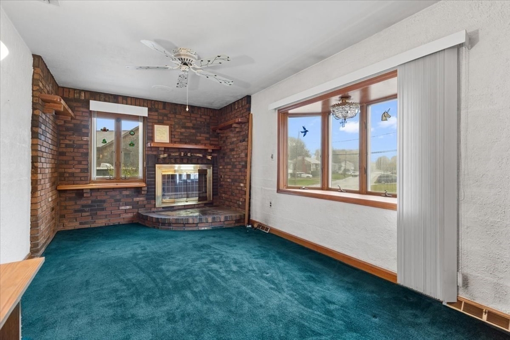 109 Merryknoll Road Weymouth, MA 02191 - Photo 11 of 41 a view of an empty room with a window and a fireplace