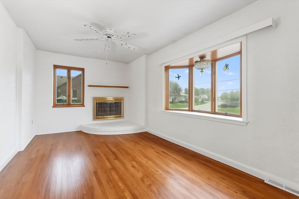 109 Merryknoll Road Weymouth, MA 02191 - Photo 12 of 41 a view of an empty room with wooden floor and a window
