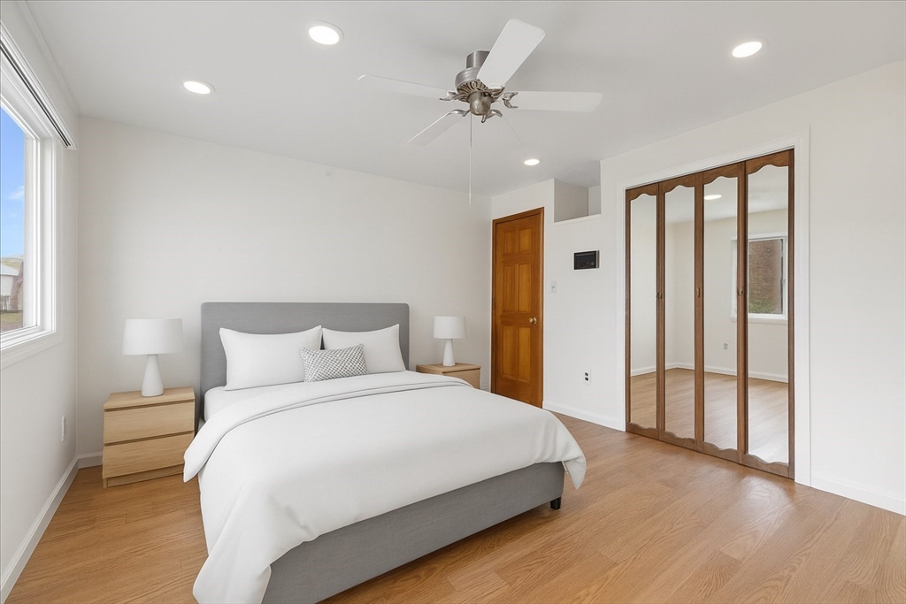 109 Merryknoll Road Weymouth, MA 02191 - Photo 16 of 41 a bedroom with a large bed and a chandelier