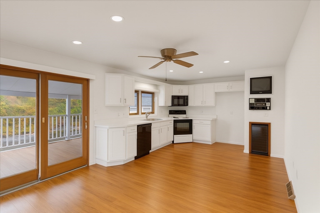 109 Merryknoll Road Weymouth, MA 02191 - Photo 22 of 41 a view of kitchen with granite countertop a sink appliances cabinets and a counter top space