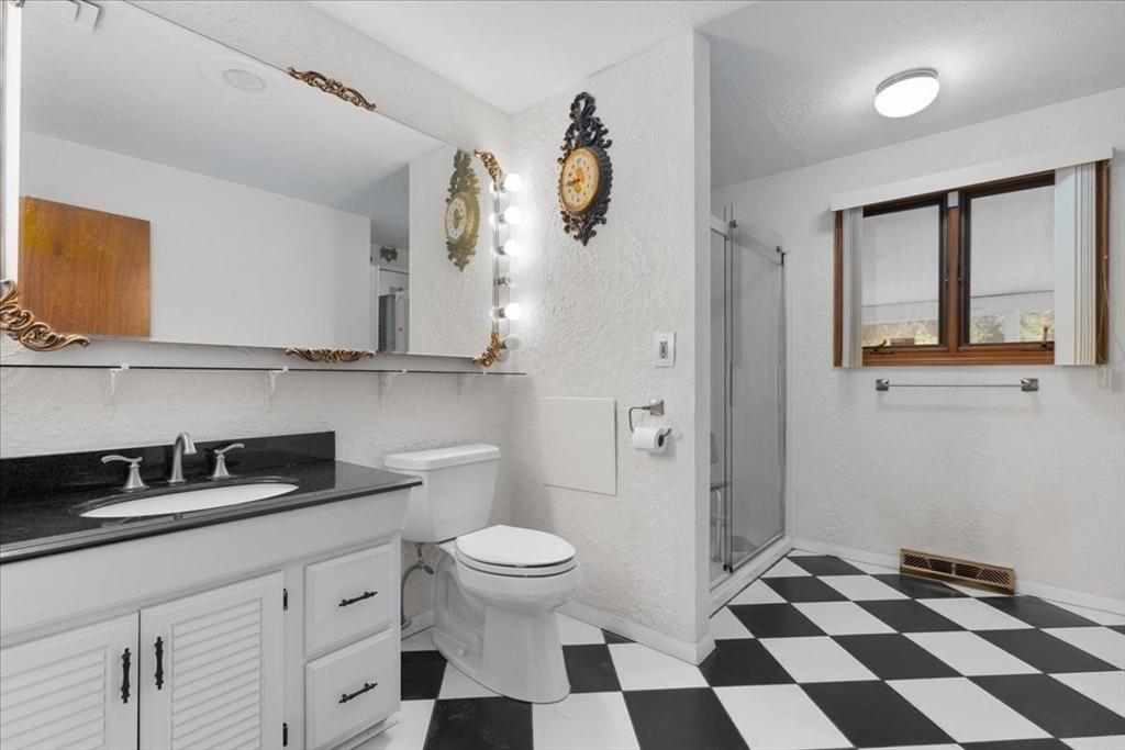 109 Merryknoll Road Weymouth, MA 02191 - Photo 23 of 41 a bathroom with a sink a toilet and a mirror