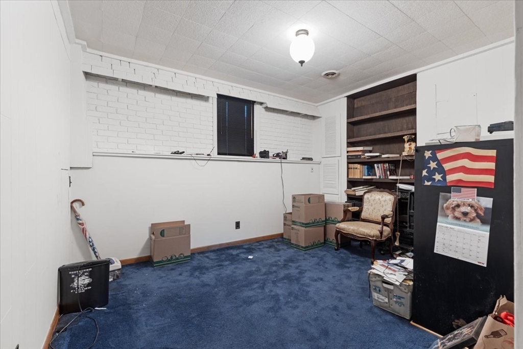 109 Merryknoll Road Weymouth, MA 02191 - Photo 31 of 41 a living room with furniture and a flat screen tv