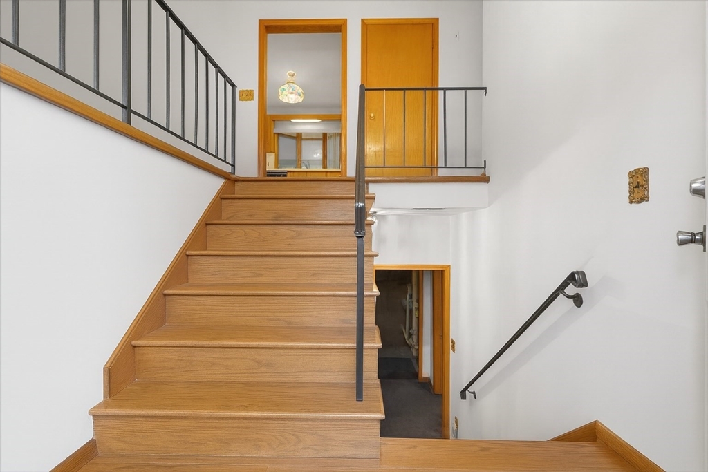 109 Merryknoll Road Weymouth, MA 02191 - Photo 4 of 41 a view of staircase with white walls and windows