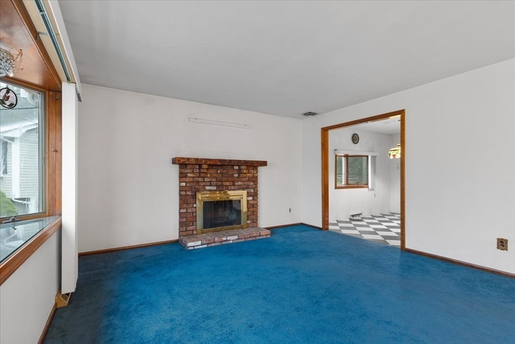 109 Merryknoll Road Weymouth, MA 02191 - Photo 5 of 41 a view of empty room with fireplace and wooden floor