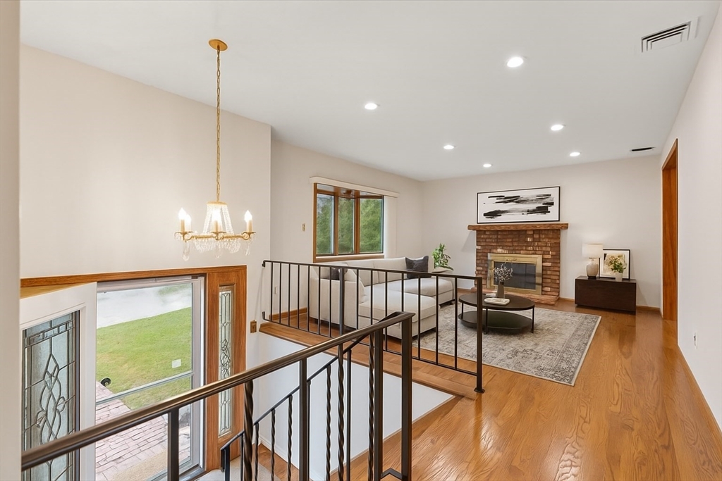 109 Merryknoll Road Weymouth, MA 02191 - Photo 8 of 41 a view of a livingroom with furniture stairs and a chandelier