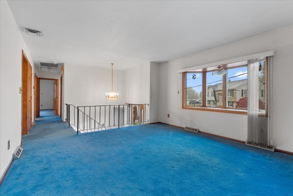 109 Merryknoll Road Weymouth, MA 02191 - Photo 9 of 41 a view of an empty room with wooden floor and a window