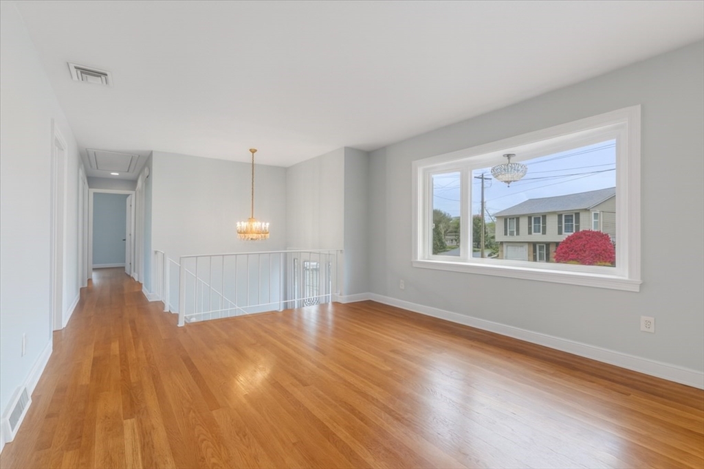 109 Merryknoll Road Weymouth, MA 02191 - Photo 10 of 41 a view of an empty room with window and wooden floor