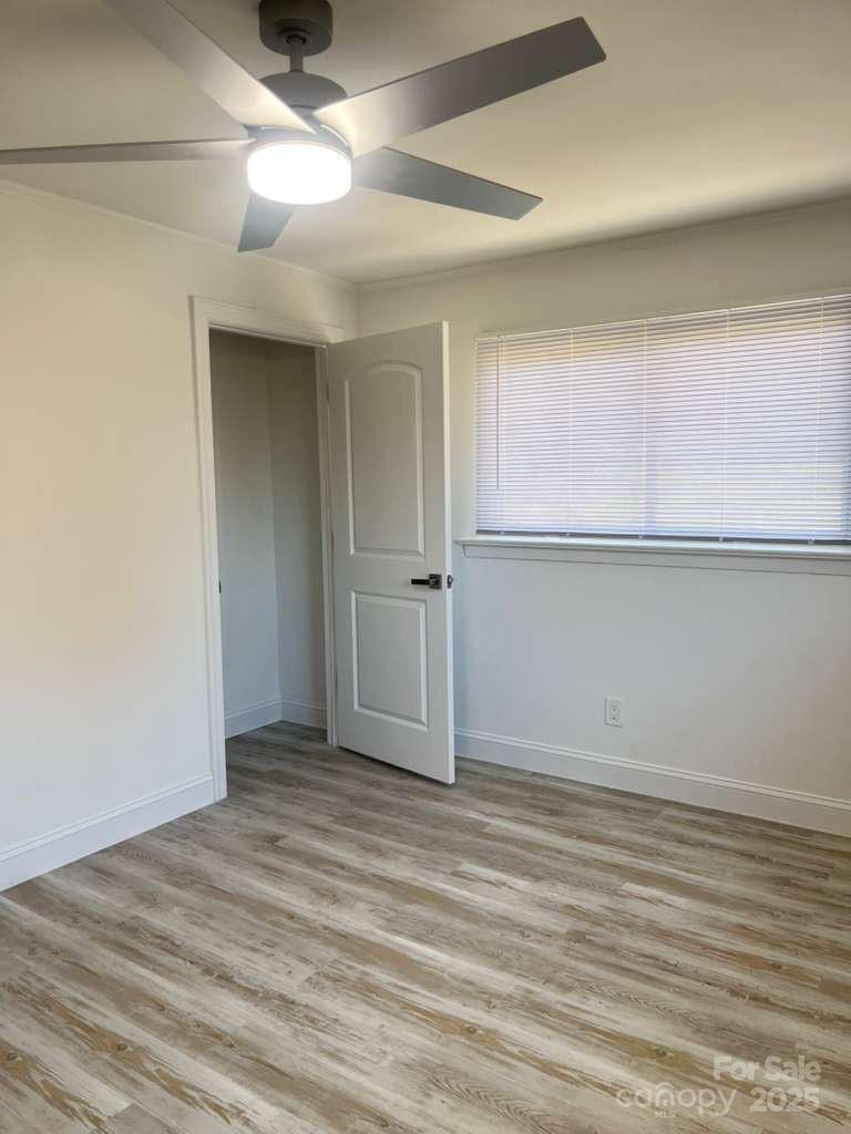 1073 Springdale Drive Maiden, NC 28650 - Photo 14 of 33 an empty room with wooden floor and cabinet