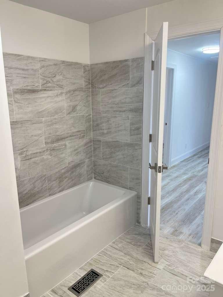 1073 Springdale Drive Maiden, NC 28650 - Photo 15 of 33 a bathroom with a bathtub and a shower