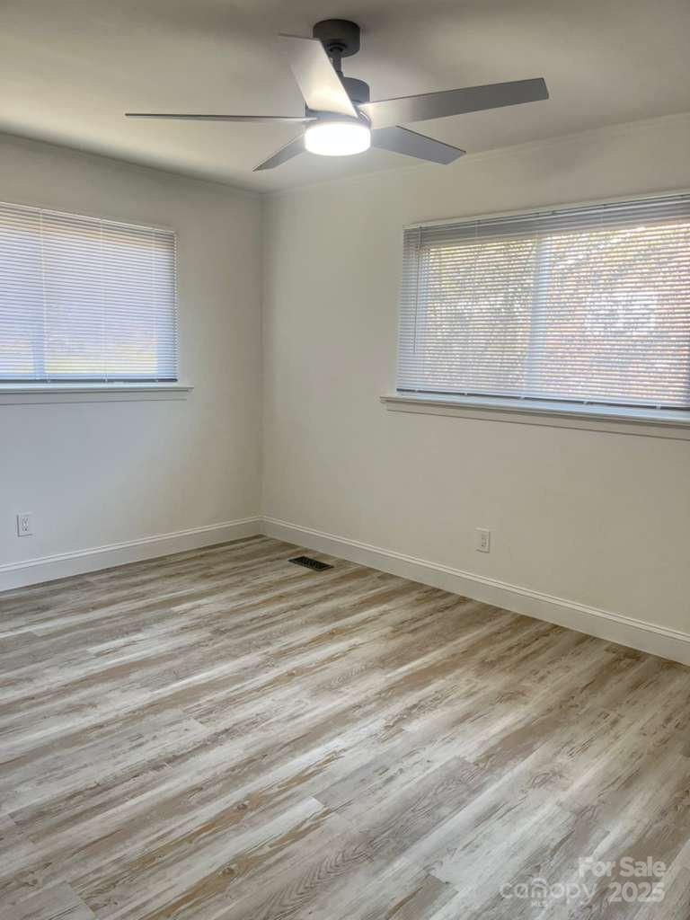 1073 Springdale Drive Maiden, NC 28650 - Photo 21 of 33 a view of empty room with wooden floor and fan