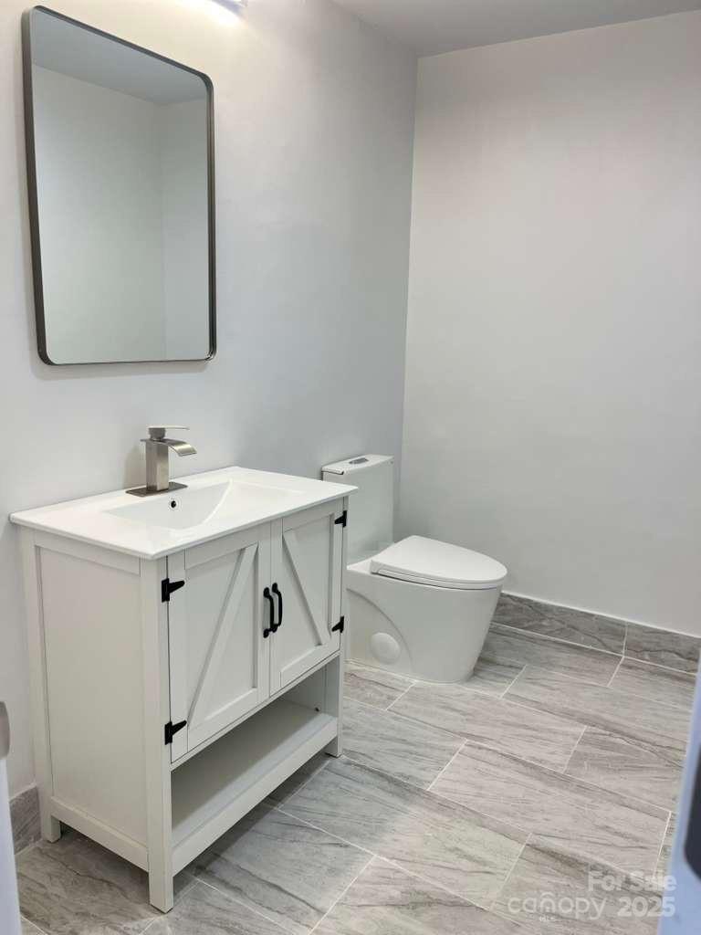 1073 Springdale Drive Maiden, NC 28650 - Photo 24 of 33 a bathroom with a toilet sink and mirror