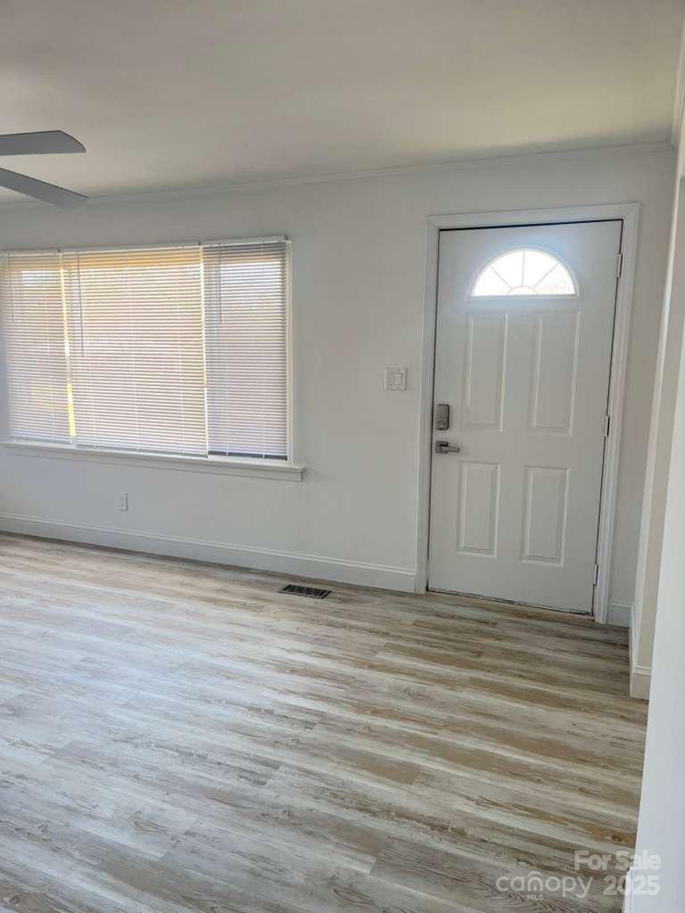 1073 Springdale Drive Maiden, NC 28650 - Photo 3 of 33 a view of an empty room with wooden floor and a window
