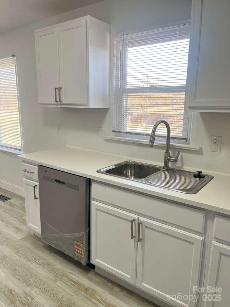 1073 Springdale Drive Maiden, NC 28650 - Photo 4 of 33 a kitchen with white cabinets and a sink