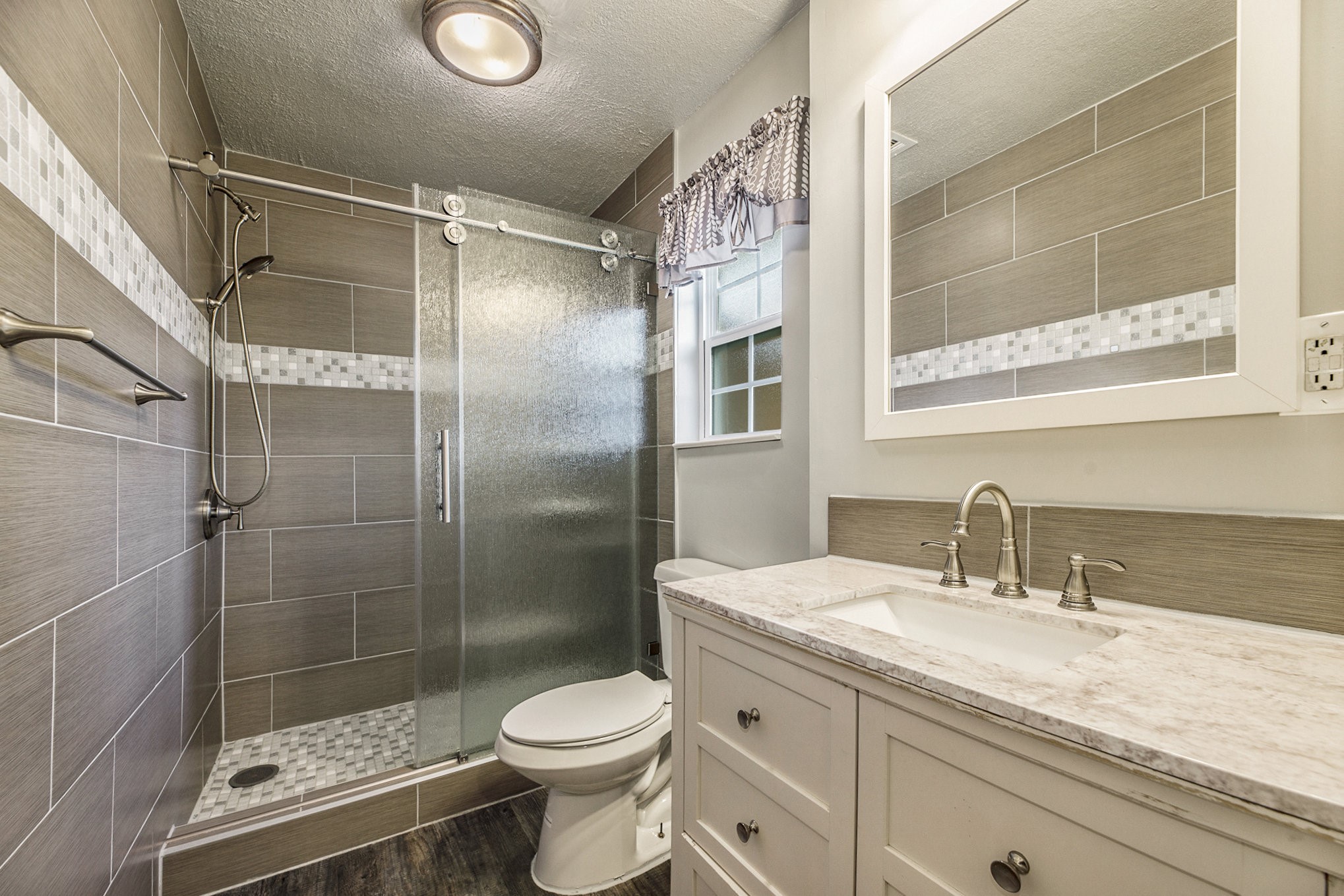 2539 Cobblers Way Friendswood, TX 77546 - Photo 14 of 19 a bathroom with a shower sink vanity mirror and toilet