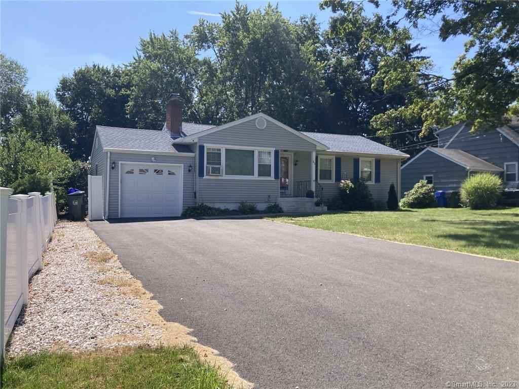52 High Ridge Drive Newington, CT 06111 - Photo 1 of 1 a front view of a house with a garden and trees