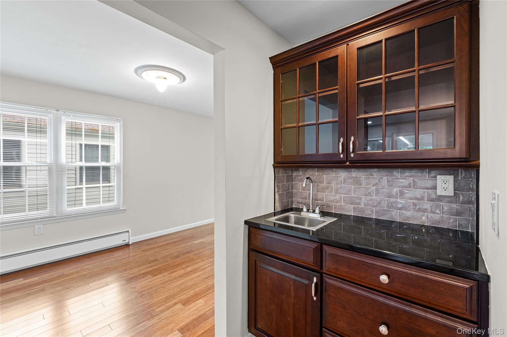220 Belfast Lane Ridge, NY 11961 - Photo 17 of 44 a kitchen with stainless steel appliances granite countertop a stove and a microwave