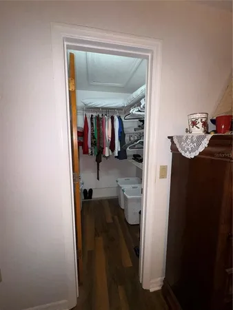 a view of walk in closet with clothes and shoes
