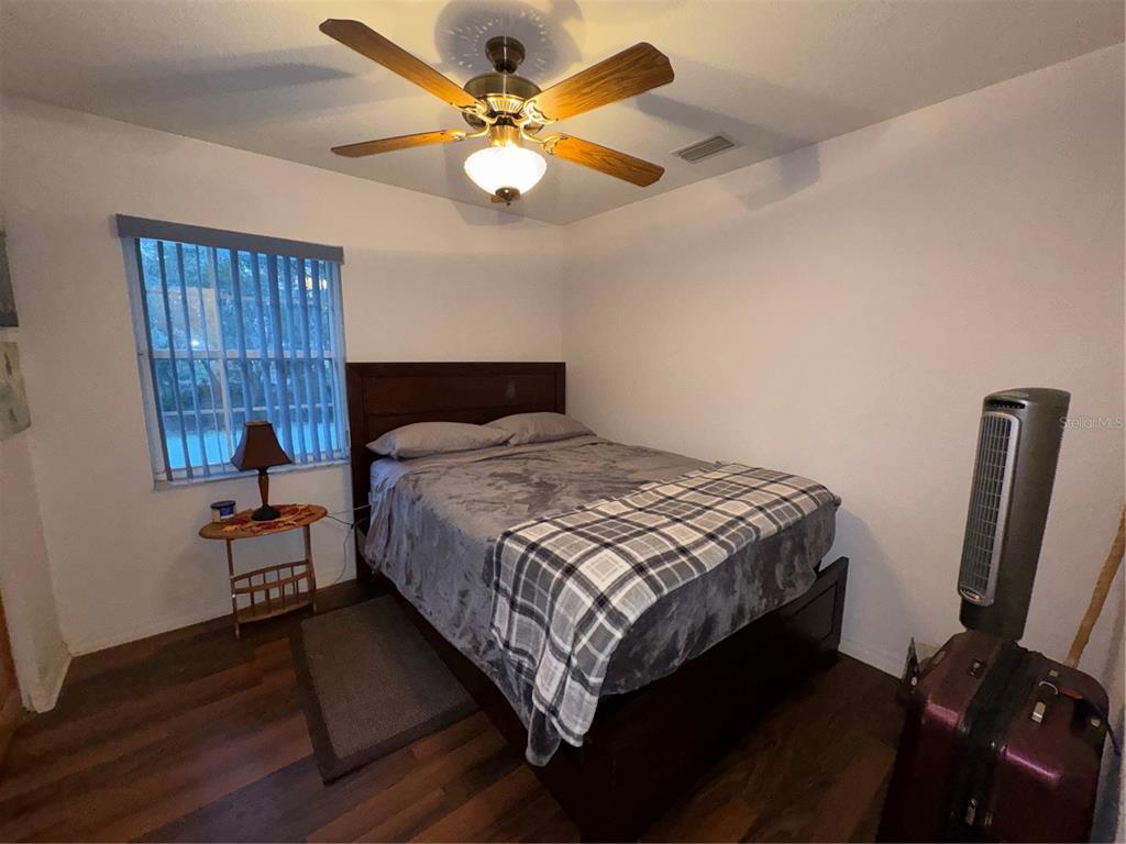 2134 R E Byrd Road Frostproof, FL 33843 - Photo 24 of 54 a bedroom with a bed and a chandelier