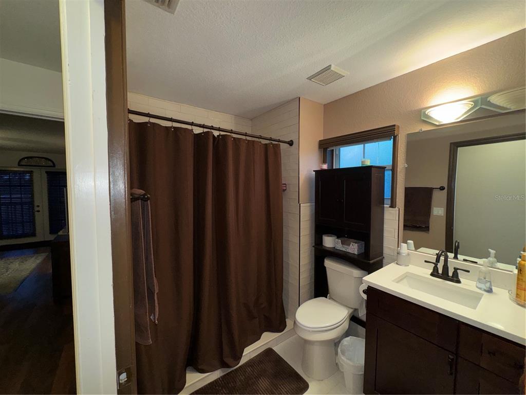 2134 R E Byrd Road Frostproof, FL 33843 - Photo 27 of 54 a bathroom with a granite countertop toilet sink and a mirror