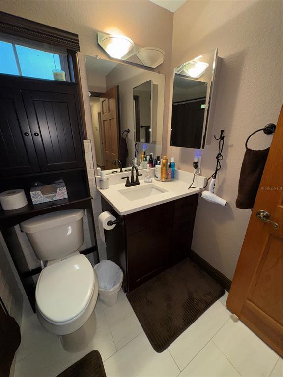 2134 R E Byrd Road Frostproof, FL 33843 - Photo 40 of 54 a bathroom with a sink a toilet and mirror