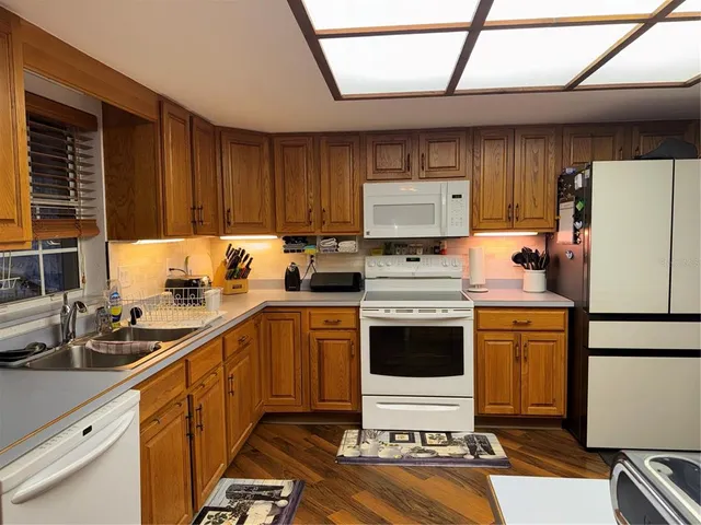 a kitchen with a refrigerator sink and stove