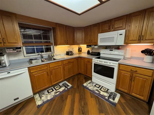 a kitchen with stainless steel appliances a stove a sink and cabinets
