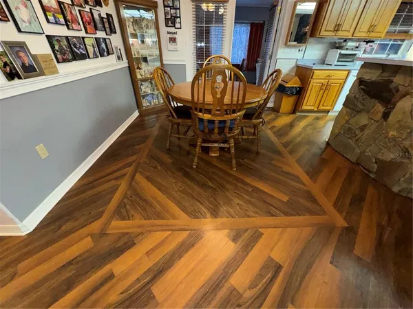 a patio with wooden floor and outdoor seating