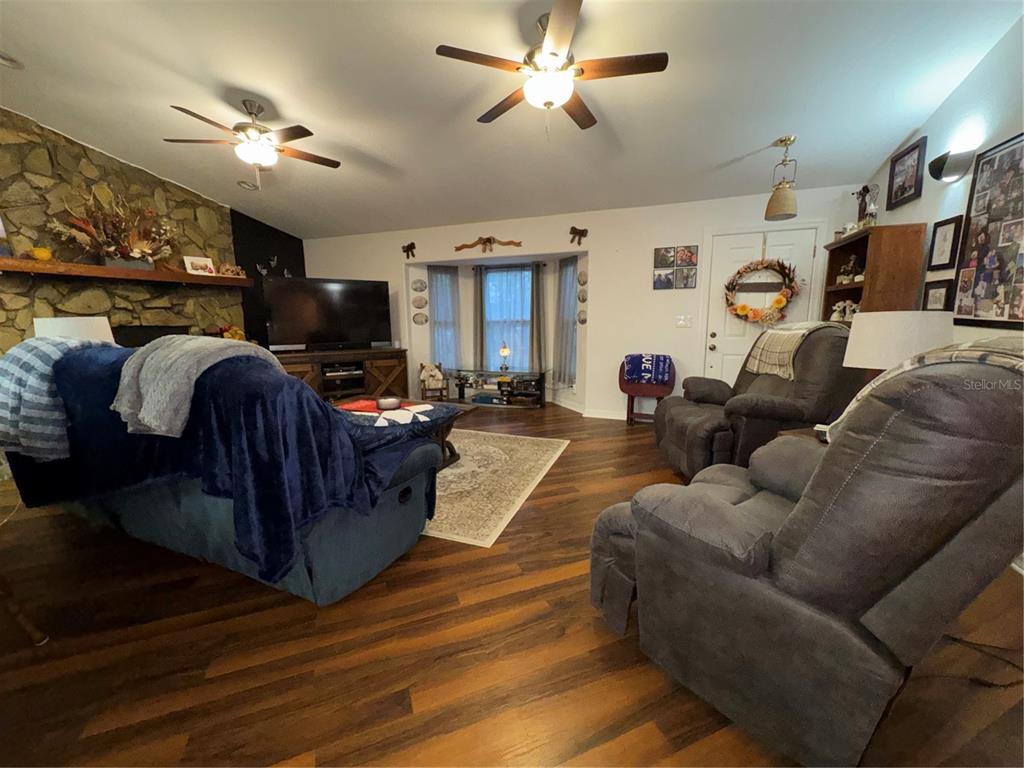 2134 R E Byrd Road Frostproof, FL 33843 - Photo 9 of 54 a living room with furniture a flat screen tv and a fireplace