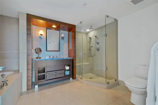 a bathroom with a double vanity sink toilet and shower