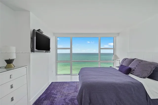 a bedroom with a bed and a television