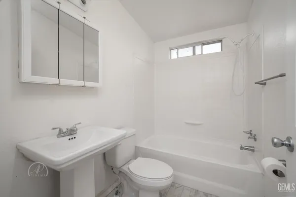 a bathroom with a sink a toilet and a bathtub