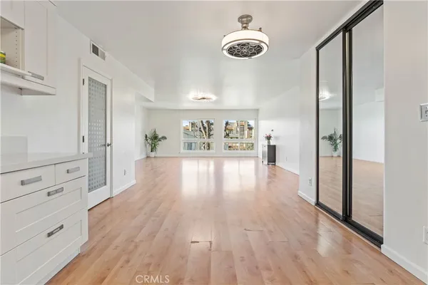 a view of a hallway view with wooden floor and windows