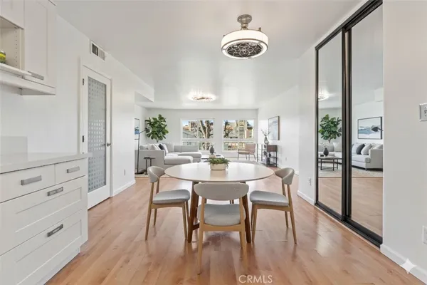 a view of a dining room with furniture window and wooden floor