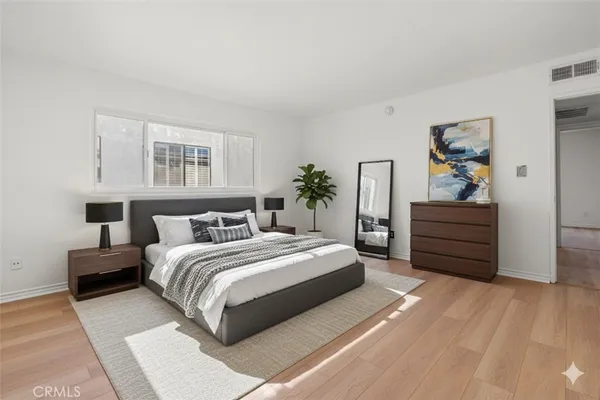 a bedroom with a bed and a dresser