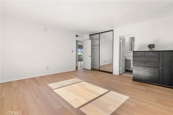an empty room with closet and cabinet