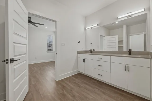 a bathroom with a double vanity sink and mirror